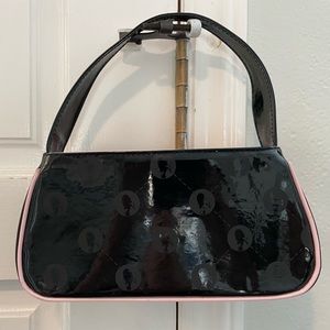 Black mini patent leather purse with baby pink accents from Too Faced